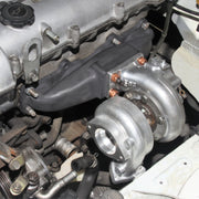Blip Speed 1.8l Miata Turbo Manifold mounted with t25 frame turbo as a part of a BEGI Miata turbo kit