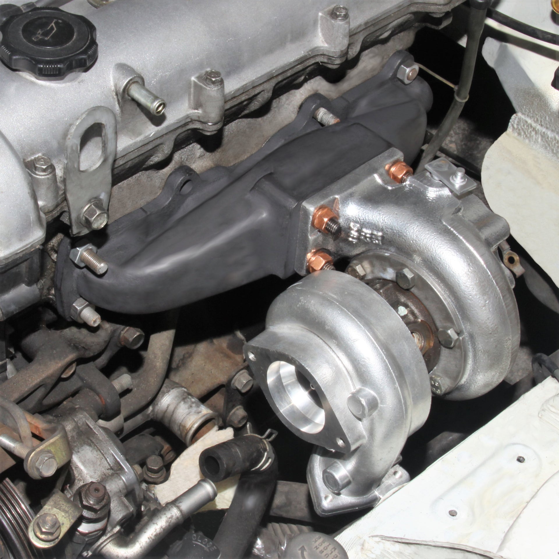 Blip Speed 1.8l Miata Turbo Manifold mounted with t25 frame turbo as a part of a BEGI Miata turbo kit